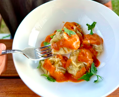 Dumplings Filled With Marinated Chicken In A Creamy Butter Chicken Sauce...